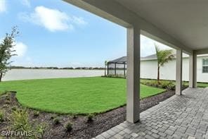 view of yard with a patio area and a water view