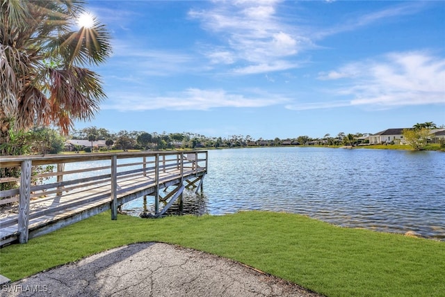 dock area featuring a yard and a water view