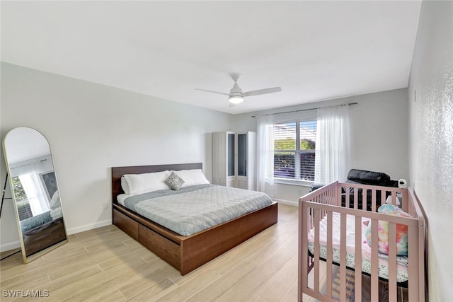 bedroom with ceiling fan and light wood-type flooring