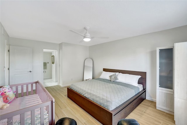 bedroom with ensuite bath and ceiling fan