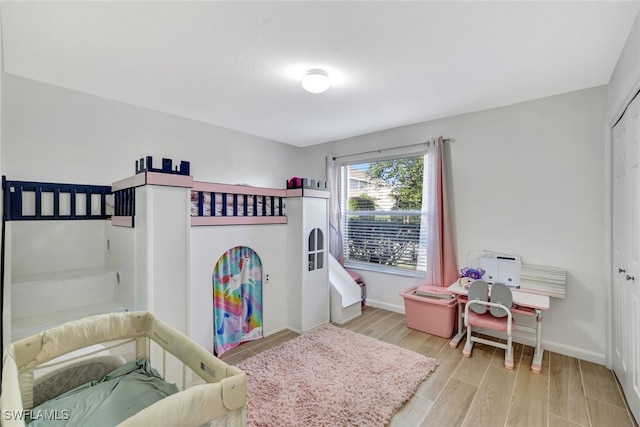 bedroom with a closet and light hardwood / wood-style floors