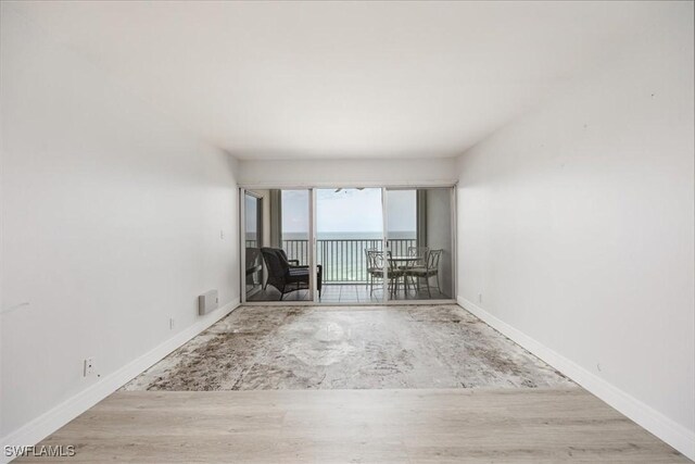 unfurnished room with wood-type flooring