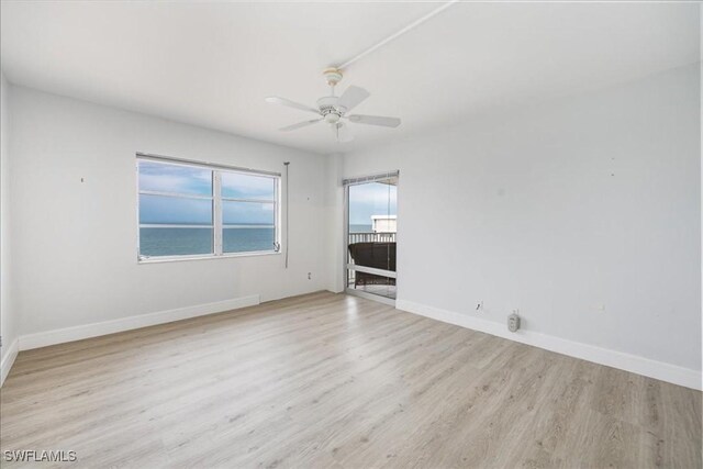 empty room with ceiling fan and light wood-type flooring