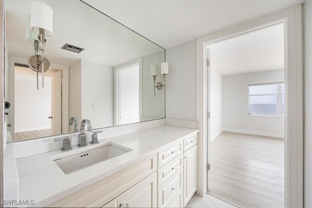 bathroom with hardwood / wood-style floors and vanity