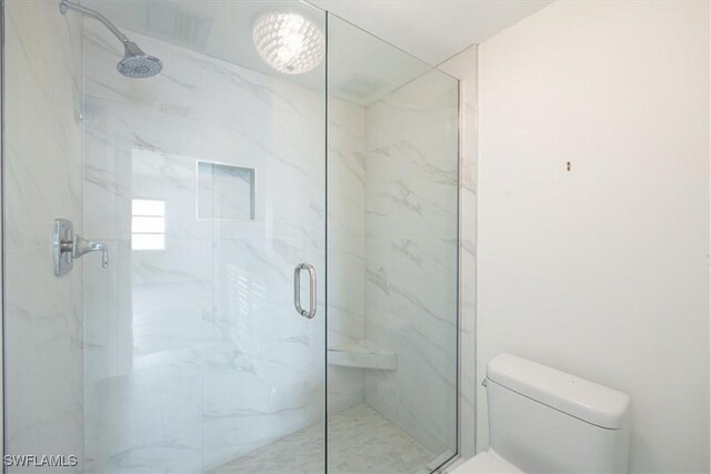 bathroom featuring an enclosed shower and toilet