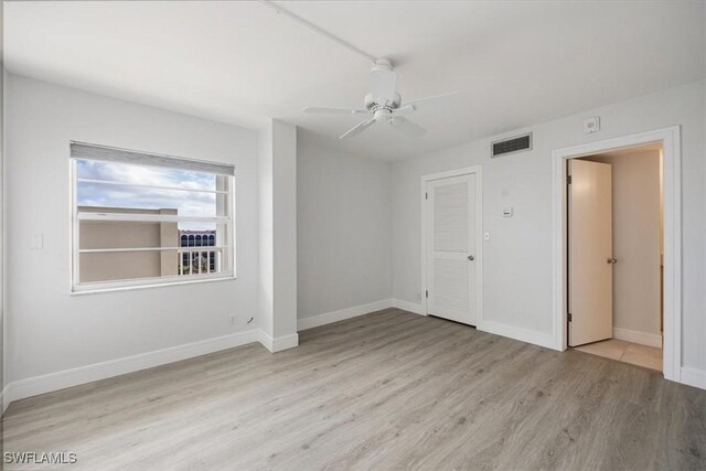 empty room featuring ceiling fan and light wood-type flooring