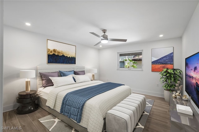 bedroom with ceiling fan and dark hardwood / wood-style flooring