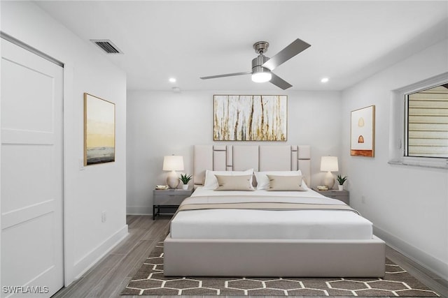 bedroom featuring ceiling fan and dark hardwood / wood-style floors