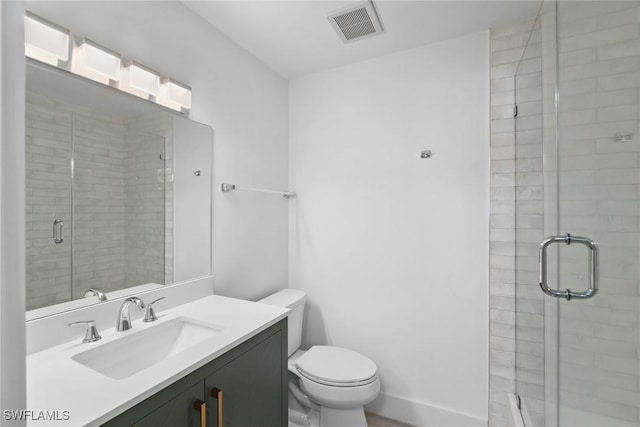 bathroom featuring vanity, toilet, and walk in shower