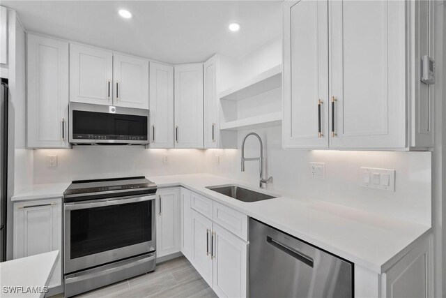 1363 Chesapeake Ave Unit B-2, Naples, FL 34102 - kitchen with stainless steel appliances, open shelves, white cabinets, light countertops, and recessed lighting