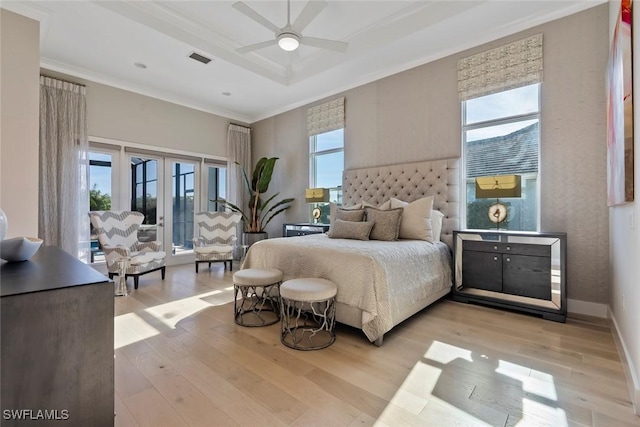 bedroom with light hardwood / wood-style floors, multiple windows, and ceiling fan