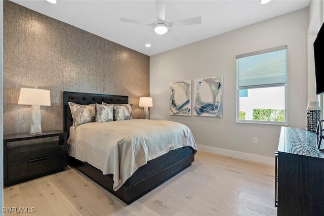 bedroom with light hardwood / wood-style flooring and ceiling fan