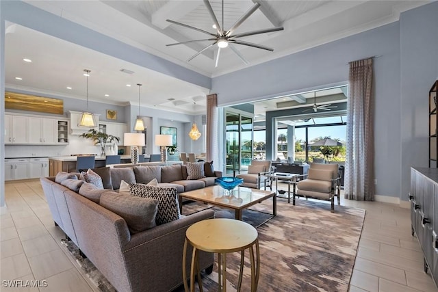 living room with ceiling fan and ornamental molding