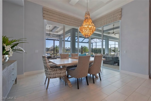 dining room with light tile patterned floors, ceiling fan with notable chandelier, and a raised ceiling