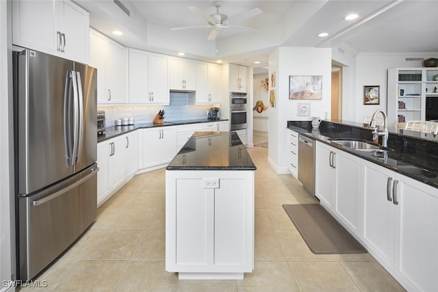 kitchen featuring dark stone countertops, sink, white cabinets, and appliances with stainless steel finishes