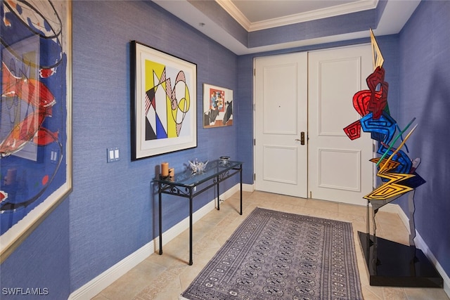 entryway featuring a raised ceiling, crown molding, and light tile patterned flooring