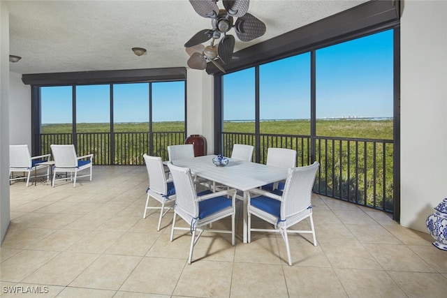 sunroom featuring ceiling fan