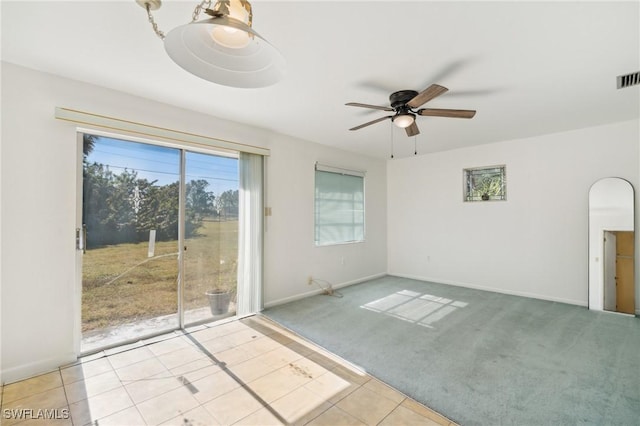 carpeted spare room with ceiling fan