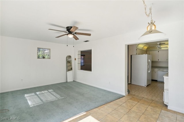 empty room with ceiling fan and light carpet