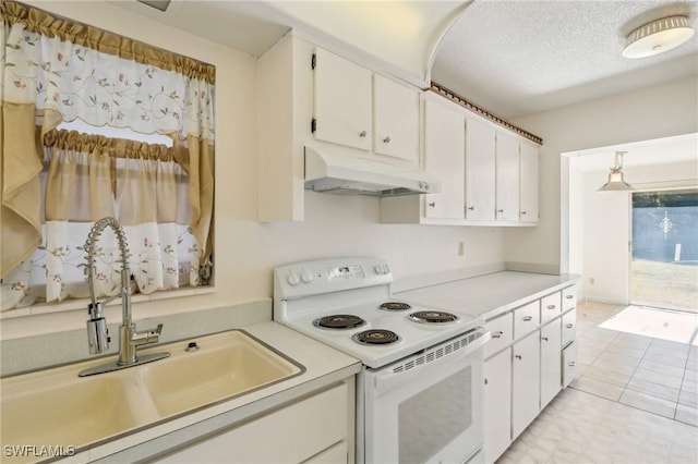 235 Thistle Ct, Lehigh Acres, FL 33936 - kitchen with electric stove, under cabinet range hood, white cabinets, light countertops, and a textured ceiling
