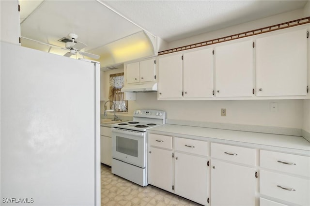 235 Thistle Ct, Lehigh Acres, FL 33936 - kitchen featuring white appliances, light flooring, ceiling fan, and white cabinetry