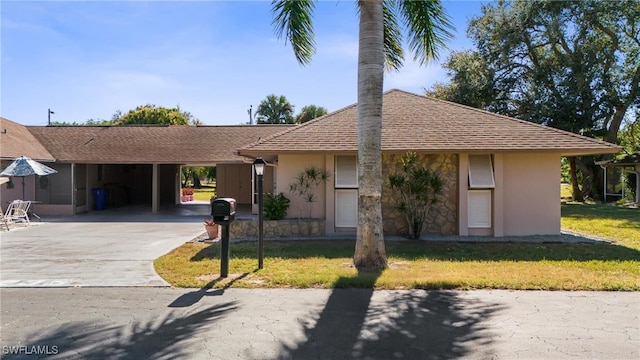 235 Thistle Ct, Lehigh Acres, FL 33936 - ranch-style house featuring driveway, stucco siding, a front yard, and a carport