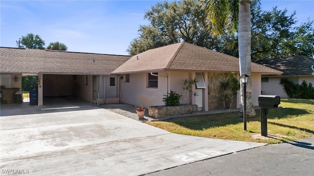235 Thistle Ct, Lehigh Acres, FL 33936 - ranch-style house with concrete driveway, stucco siding, a front lawn, and an attached carport