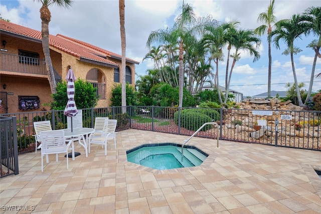 view of pool with a community hot tub and a patio