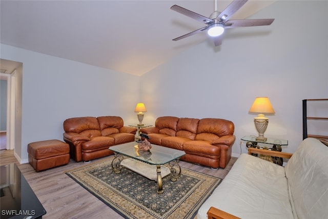 living room featuring ceiling fan, lofted ceiling, and light wood-type flooring