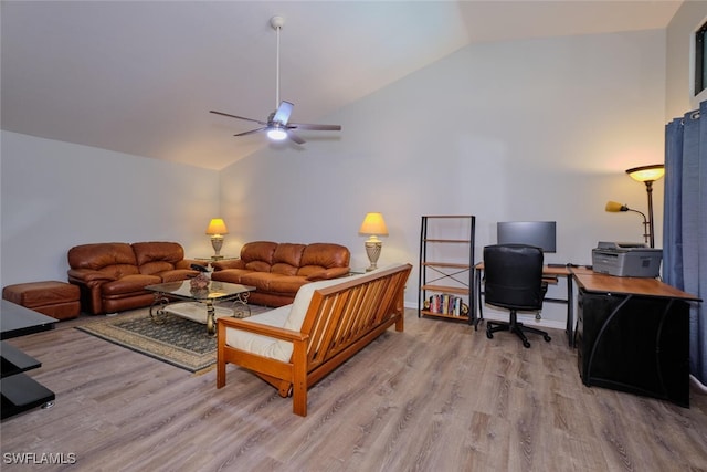 living room featuring ceiling fan, light hardwood / wood-style floors, and vaulted ceiling