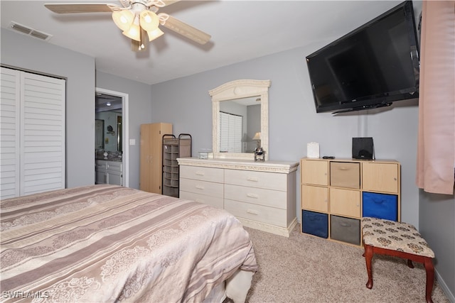 carpeted bedroom with a closet and ceiling fan