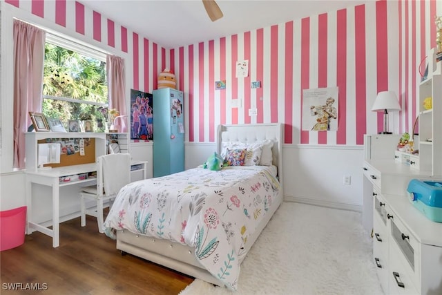 bedroom with light hardwood / wood-style floors and ceiling fan