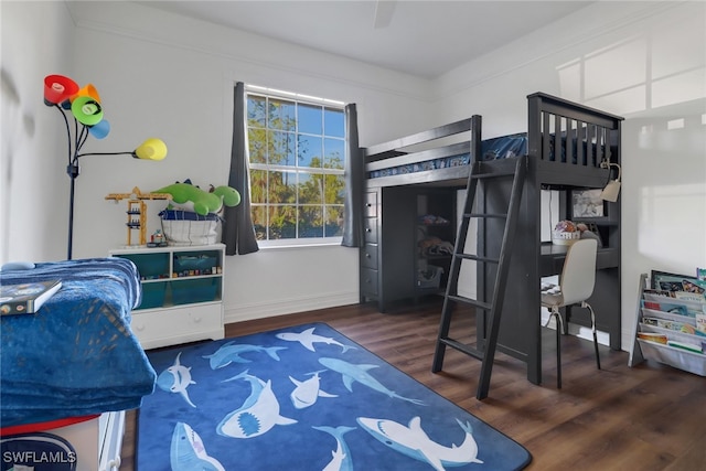 bedroom with dark wood-type flooring