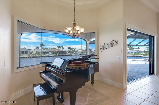 miscellaneous room with light tile patterned floors, a water view, and an inviting chandelier