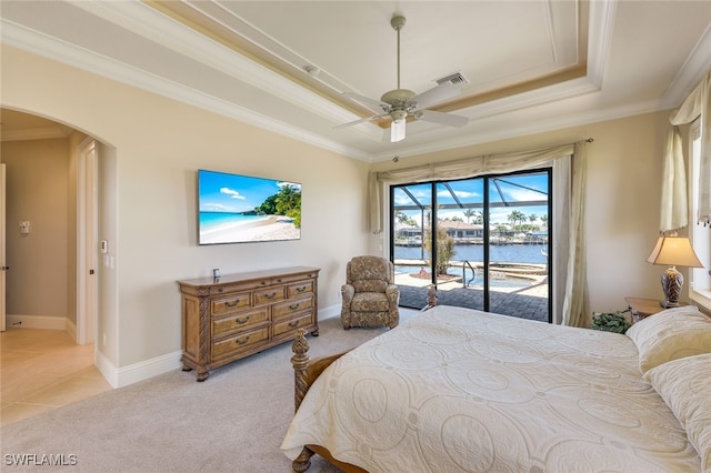 bedroom with access to exterior, ornamental molding, light colored carpet, a tray ceiling, and ceiling fan