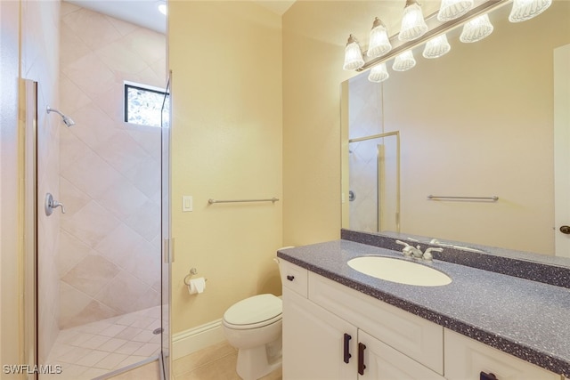 bathroom featuring tile patterned flooring, vanity, a shower with shower door, and toilet