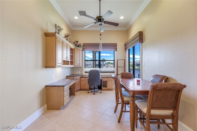 tiled office space with crown molding, ceiling fan, and built in desk