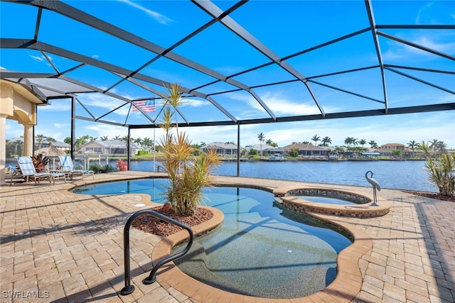 view of swimming pool with a lanai, an in ground hot tub, and a water view