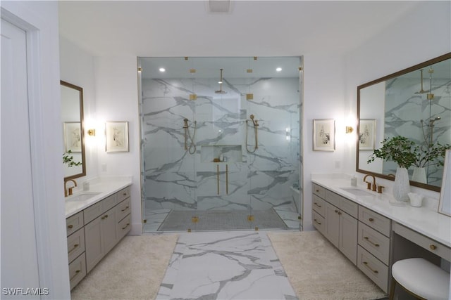 full bath featuring marble finish floor, two vanities, a sink, and a marble finish shower