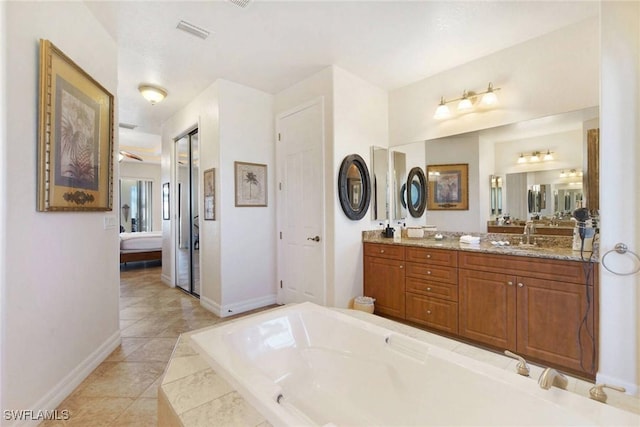 bathroom featuring tile patterned flooring, vanity, and ceiling fan