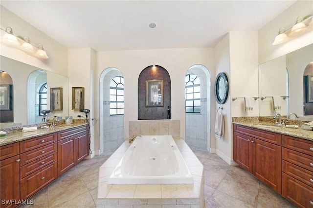 bathroom with vanity, plus walk in shower, and a wealth of natural light