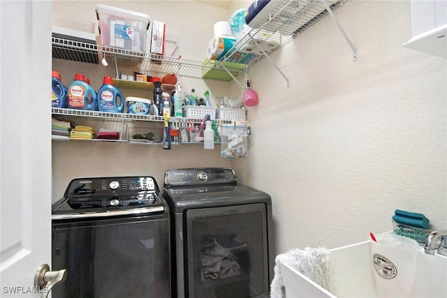 clothes washing area with separate washer and dryer and sink