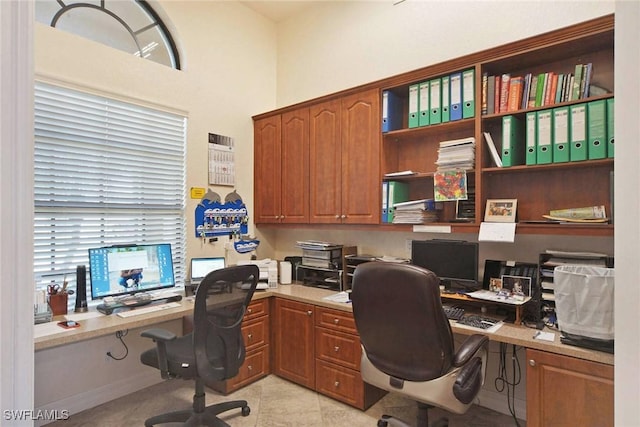 office area featuring light tile patterned flooring and built in desk