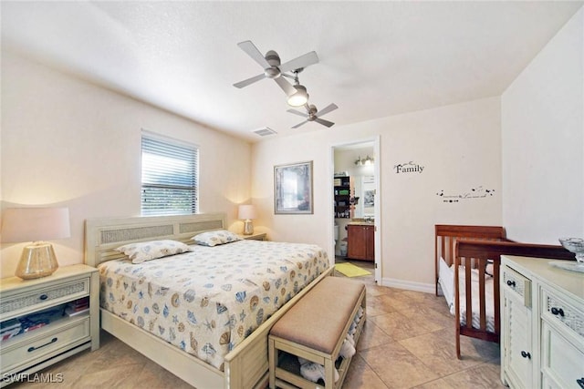 bedroom featuring ceiling fan, light tile patterned floors, and ensuite bathroom