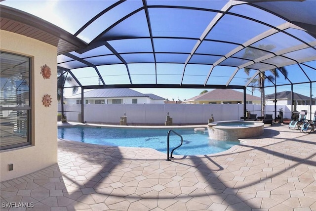 view of pool featuring glass enclosure, a patio area, and an in ground hot tub