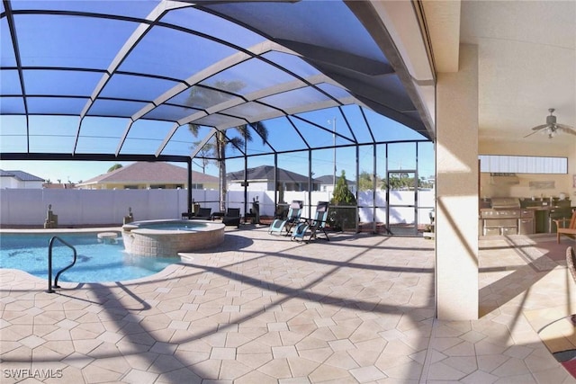 view of swimming pool featuring ceiling fan, a patio area, a lanai, and an in ground hot tub