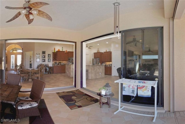 sunroom / solarium featuring french doors and ceiling fan