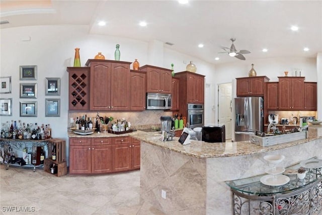 kitchen with tasteful backsplash, light stone counters, a breakfast bar, stainless steel appliances, and ceiling fan