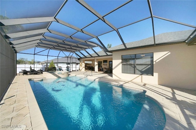 view of swimming pool with glass enclosure, a patio area, and an in ground hot tub