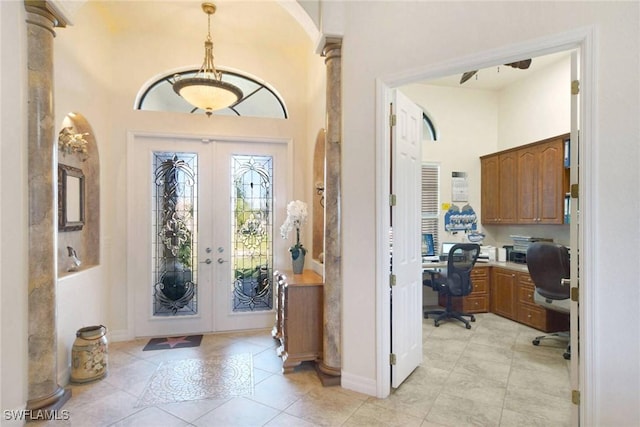 tiled entrance foyer with built in desk and french doors